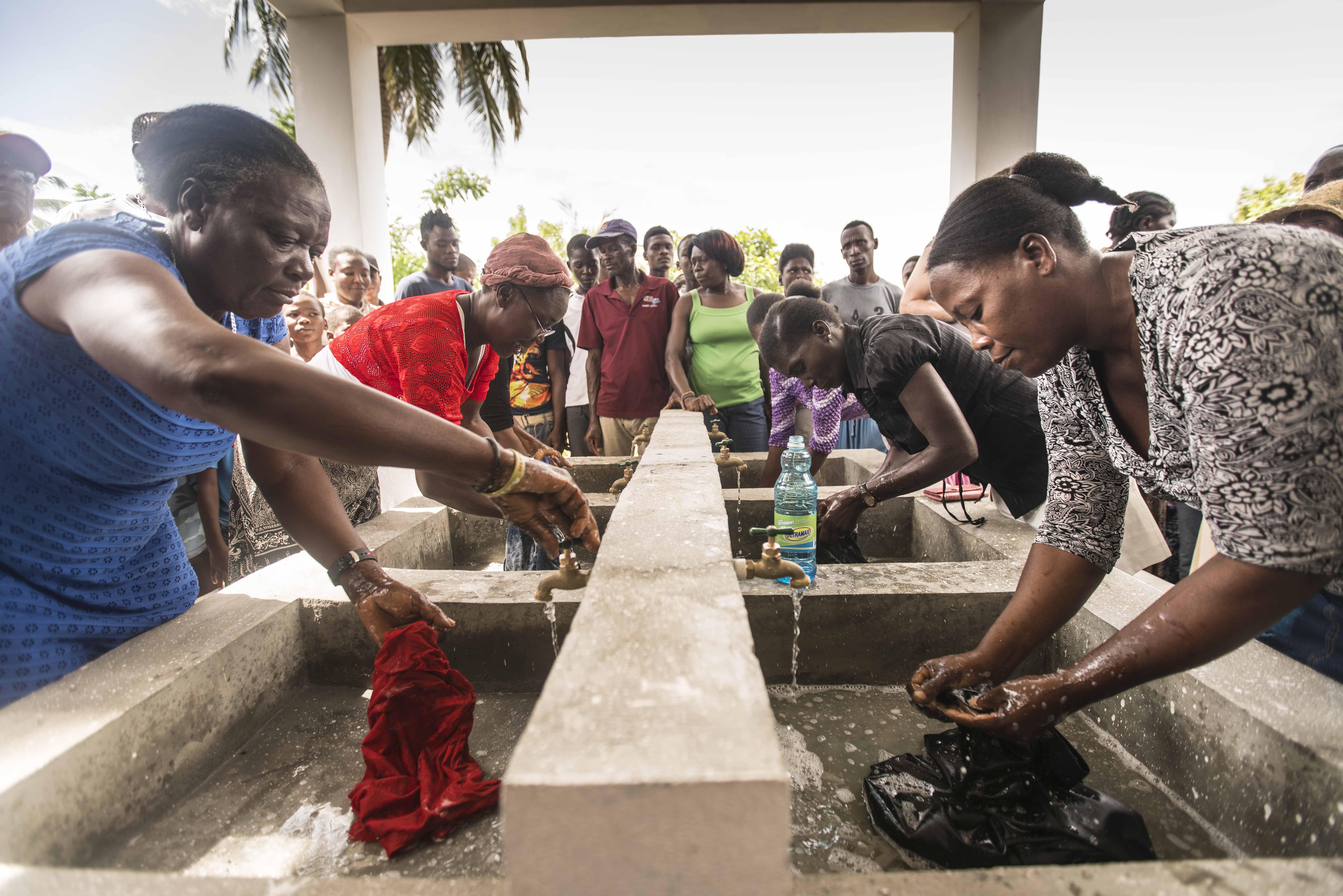 Women in Haiti washing clothes in a facility built by the Foundation